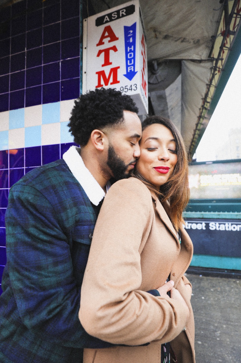 Couple embracing against cobalt subway tile