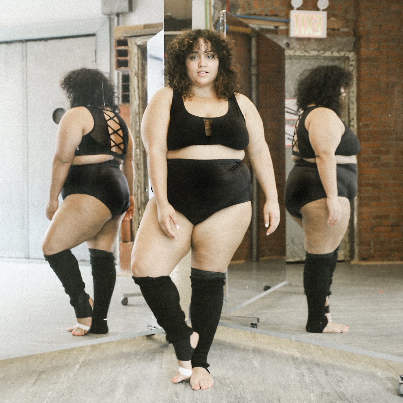 Dancer reflected in three studio mirrors